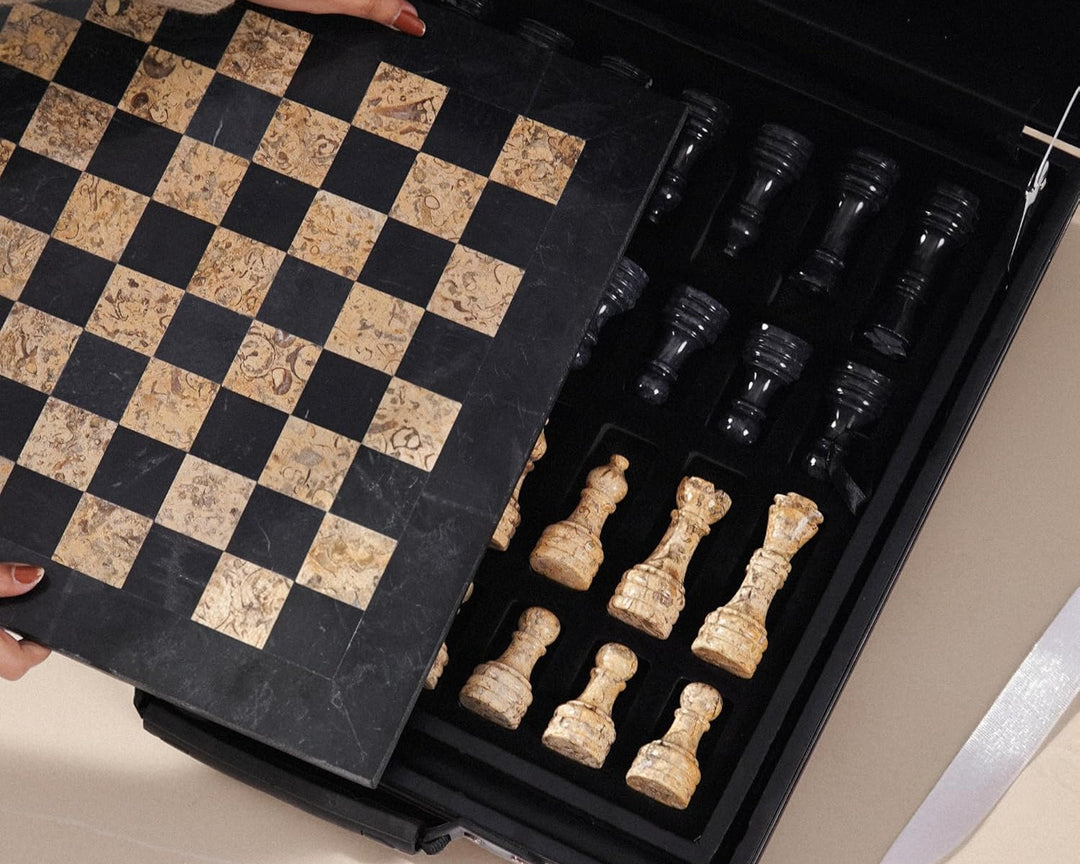 Open chess set with pieces and checkered board in a black box.