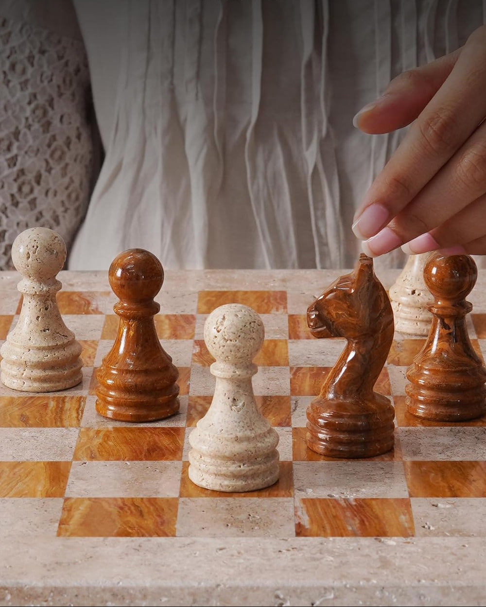 Hand moving a chess piece on a checkered board with 'Speeshstones' branding.