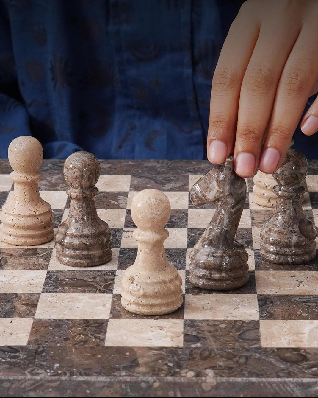 Person playing chess with a focus on pieces and checkers, featuring the Speshstones brand.