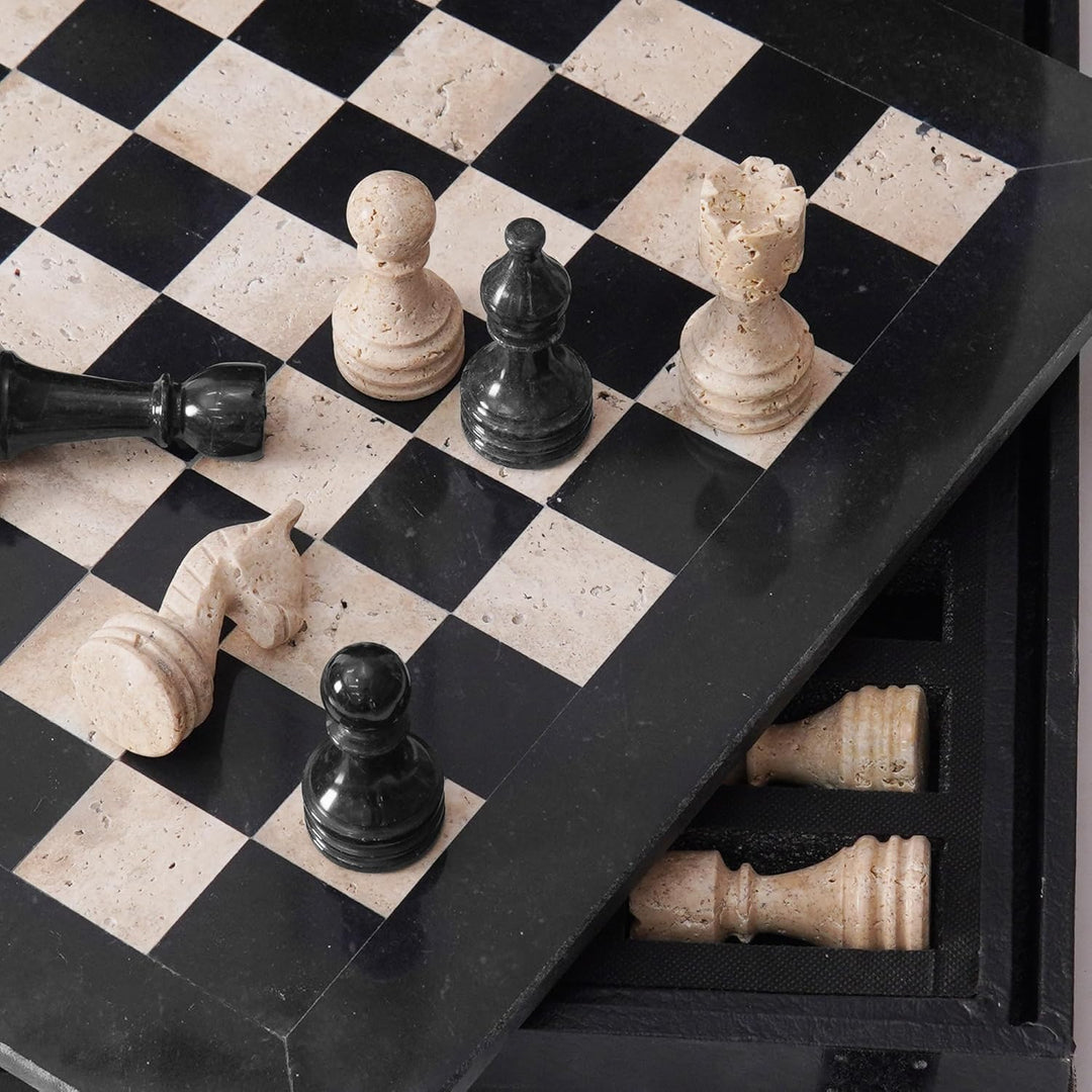 Black and white stone chess pieces on a checkered board with a drawer open.