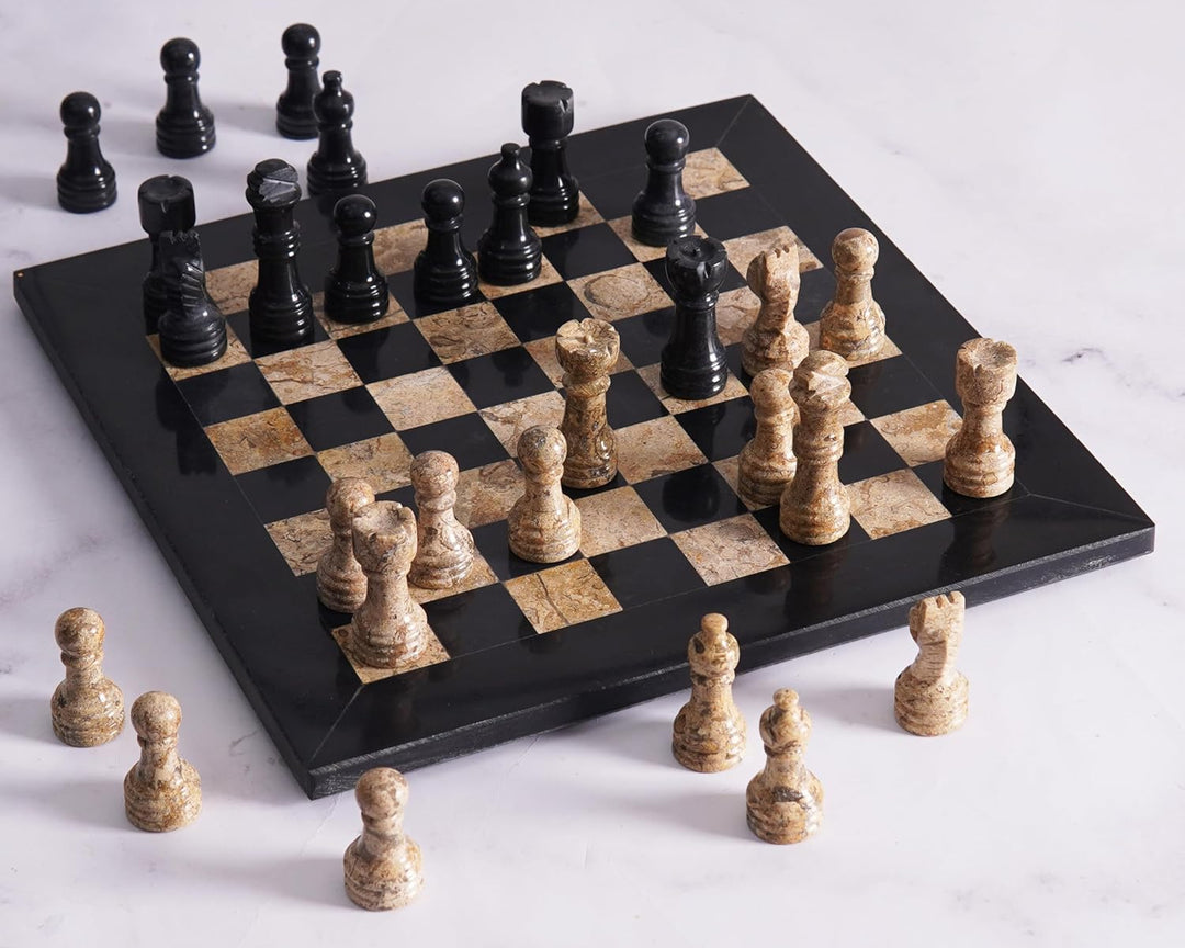 Marble chess set with black and beige pieces on a white background