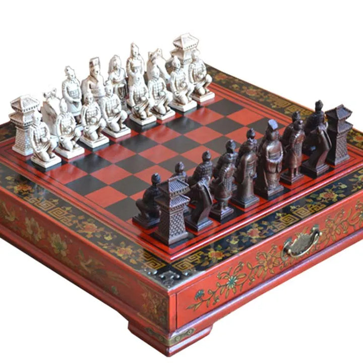 A wooden chessboard with a historical terracotta warriors theme, including a red and green color scheme and decorative elements. The chess pieces are in the middle of the board, ready for a game.