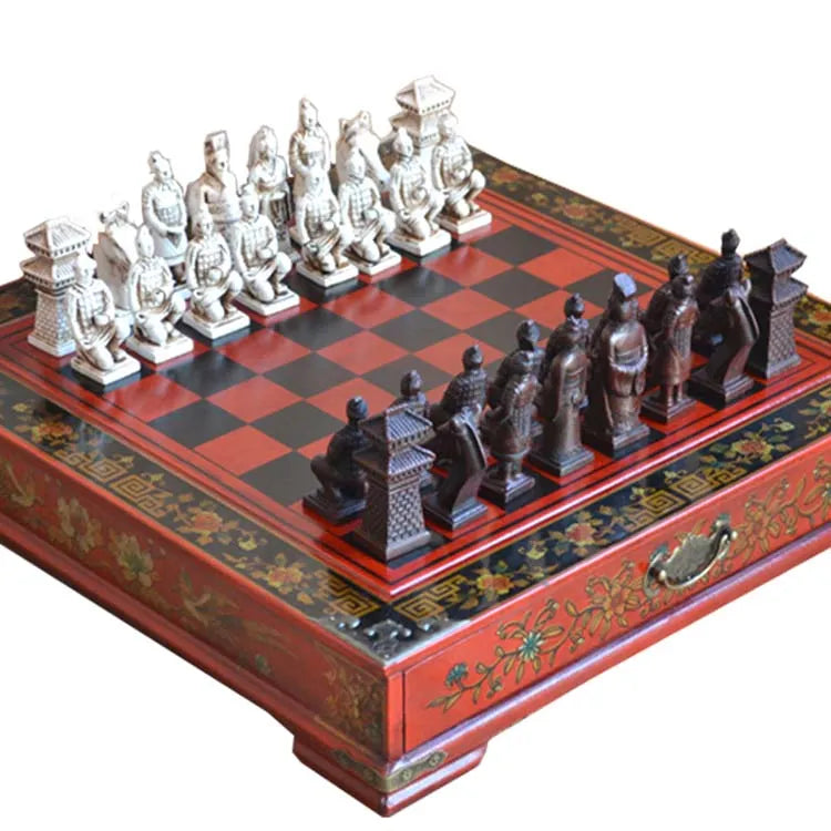 A wooden chessboard with a historical terracotta warriors theme, including a red and green color scheme and decorative elements. The chess pieces are in the middle of the board, ready for a game.
