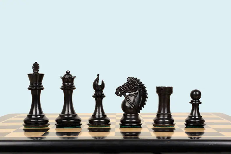 Set of black chess pieces on a wooden chessboard with a light blue background
